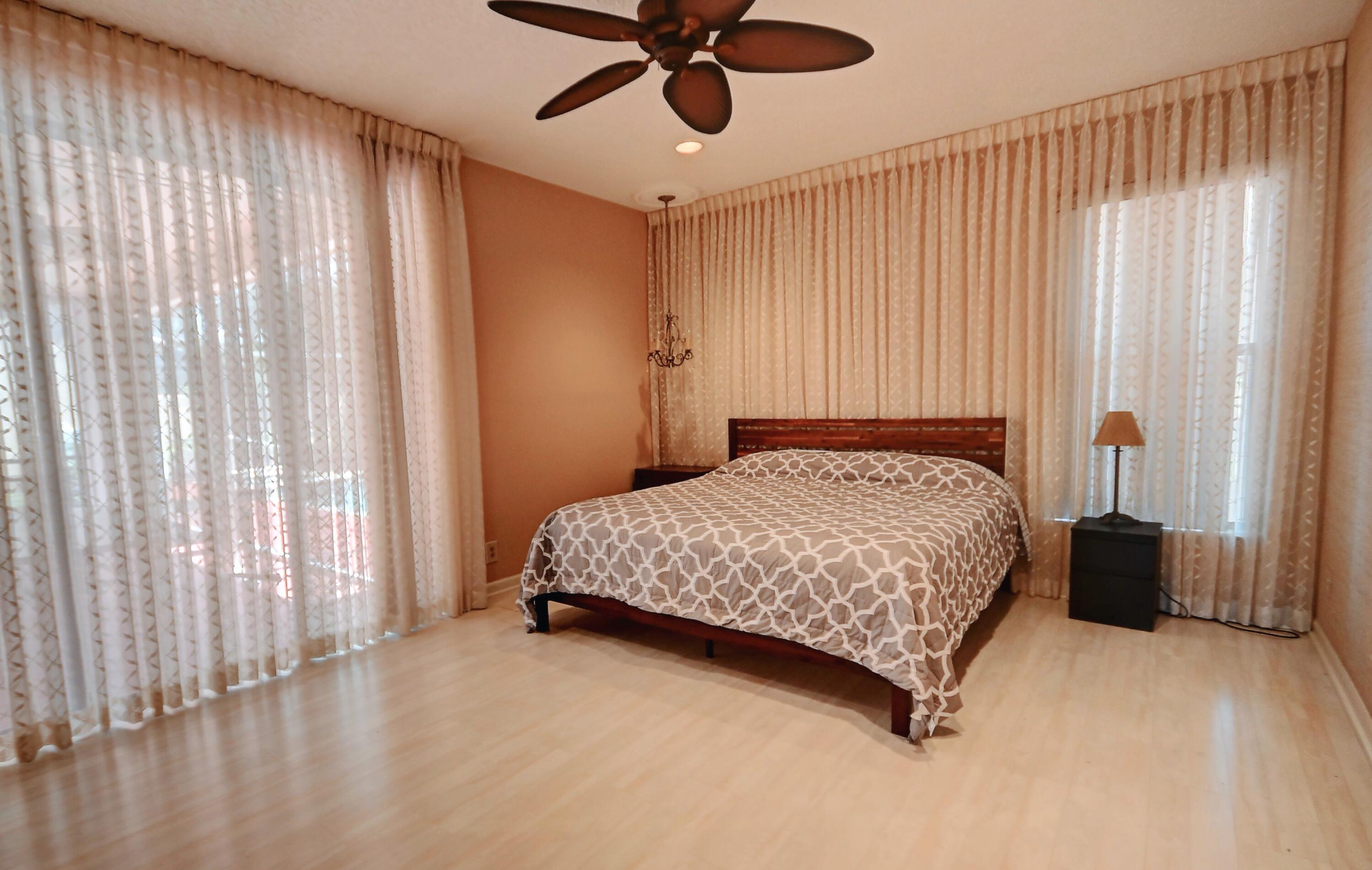 19356 Cherry Hills Terrace Boca Raton, FL 33498 - Photo 8 of 22 a bedroom with a bed and a window