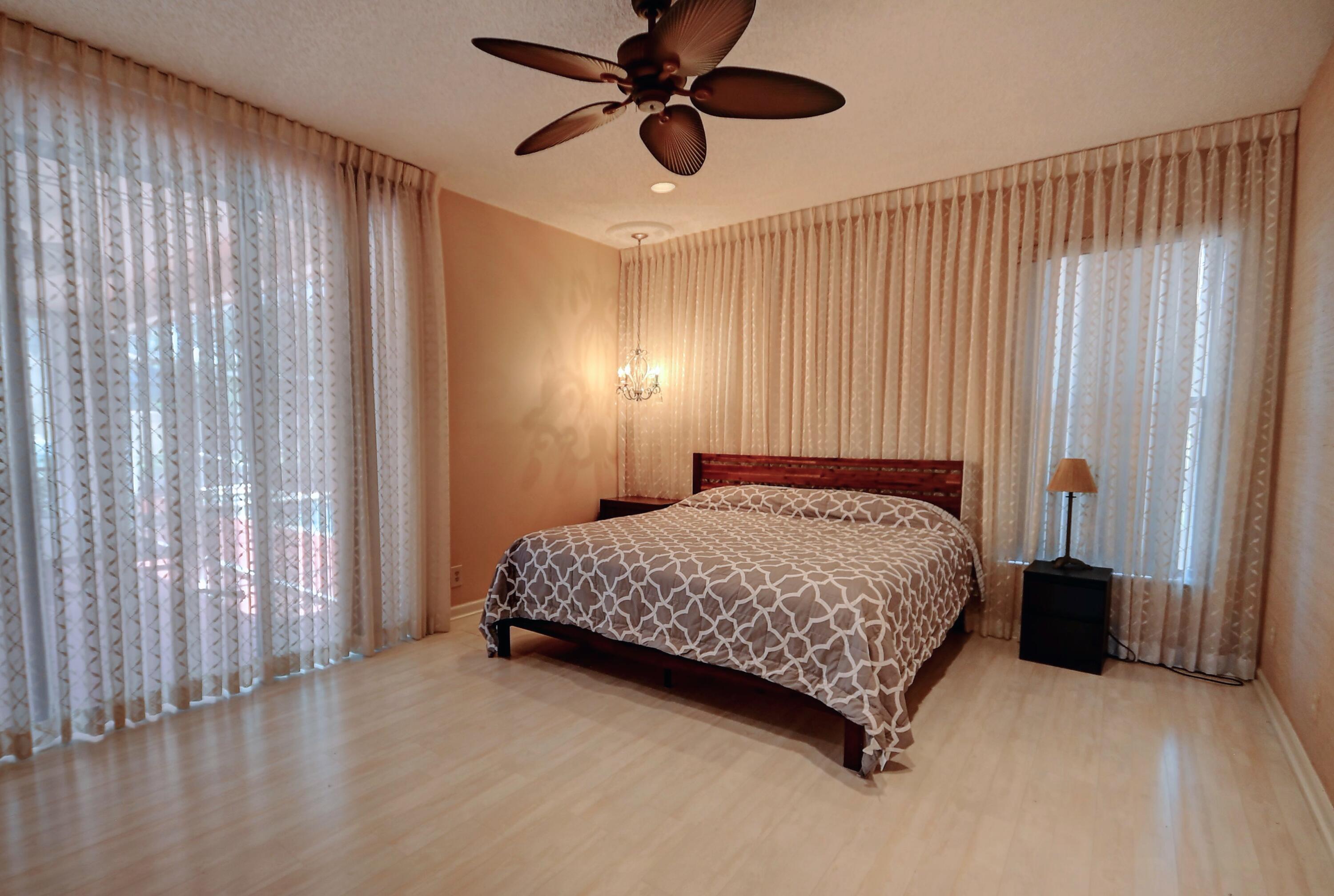 19356 Cherry Hills Terrace Boca Raton, FL 33498 - Photo 9 of 22 a bedroom with a bed and a window