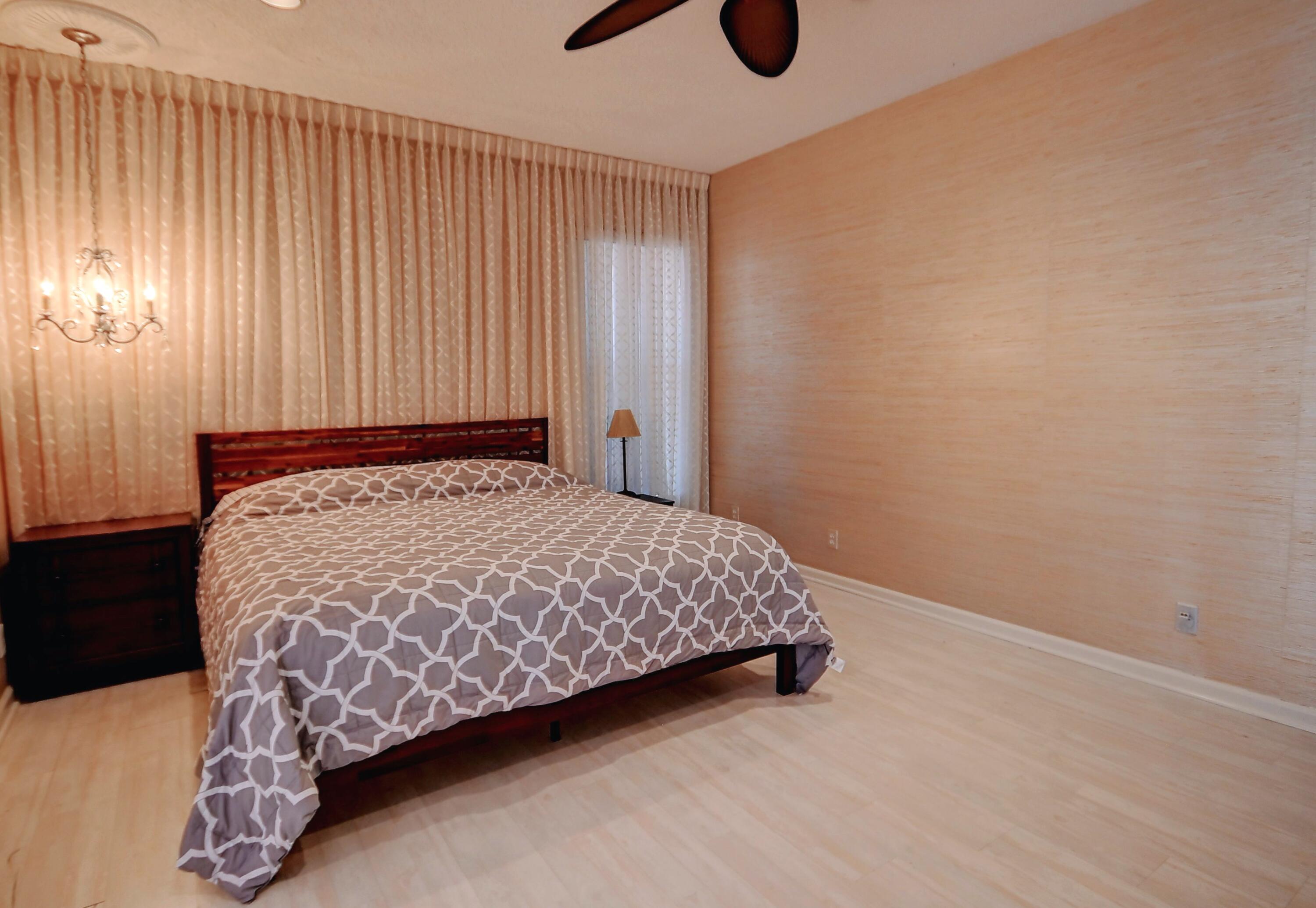 19356 Cherry Hills Terrace Boca Raton, FL 33498 - Photo 10 of 22 a bedroom with a bed and a window