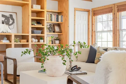 a living room with furniture and flowers