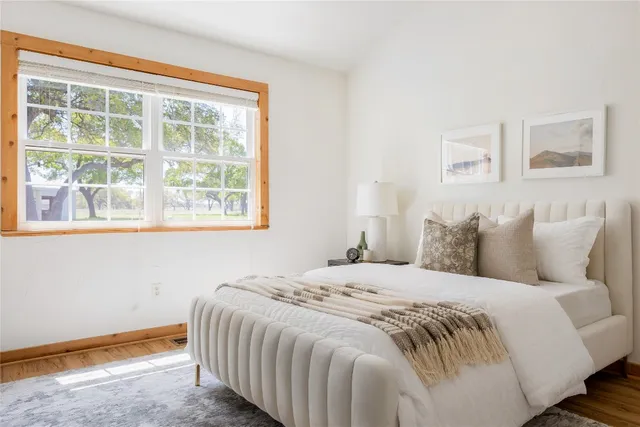 a bedroom with a bed and a window