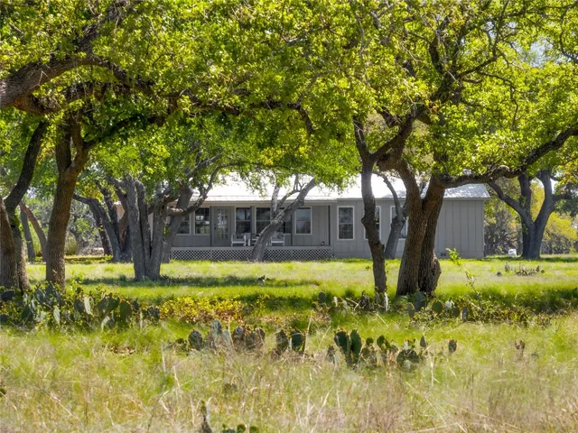 a view of a house with a large tree