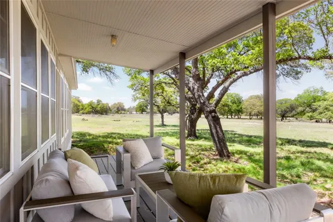 a view of a living room with furniture and garden view