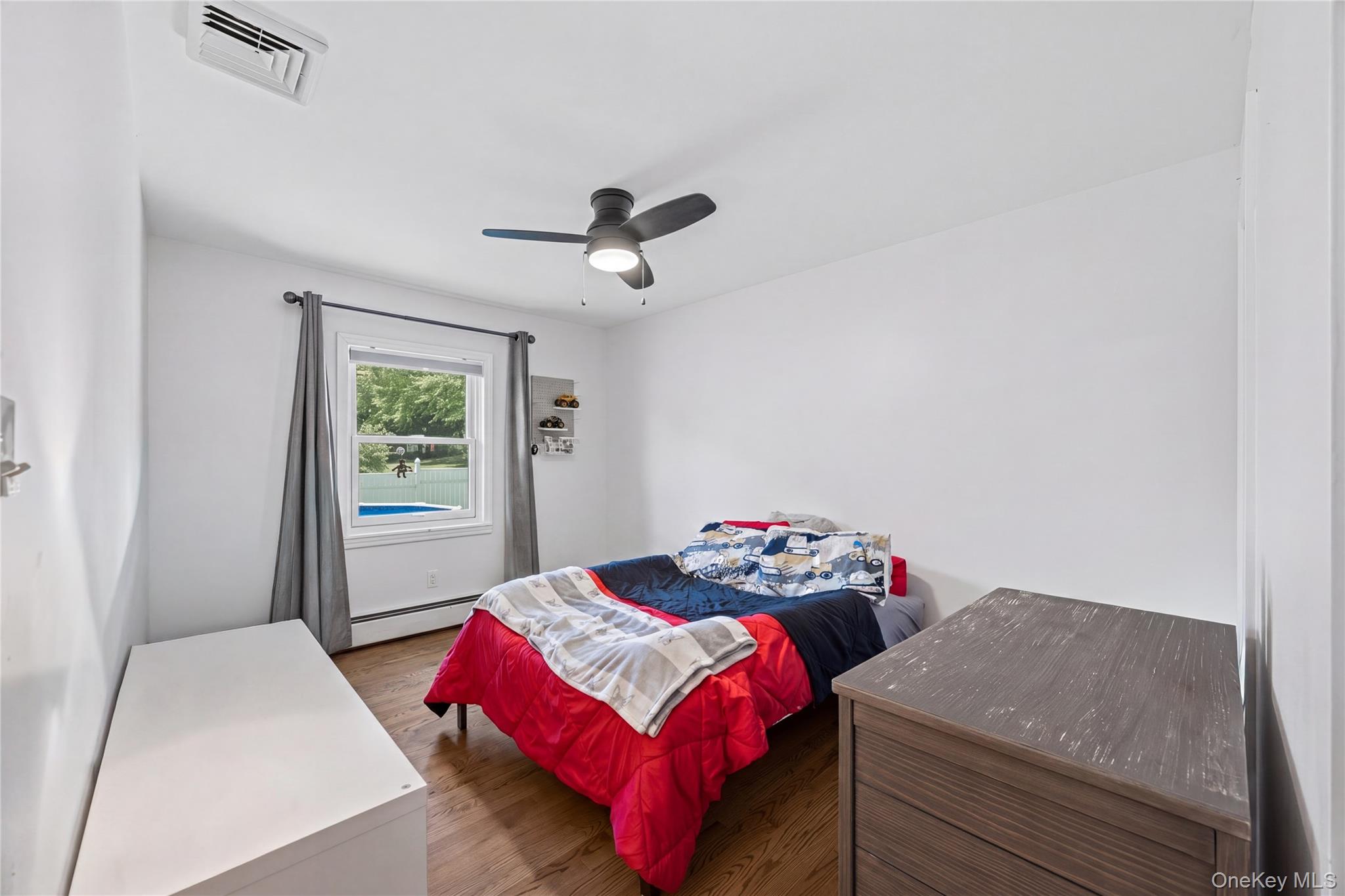 69 Silver Spring Road New Windsor, NY 12553 - Photo 19 of 20 a bedroom with a bed and a chandelier