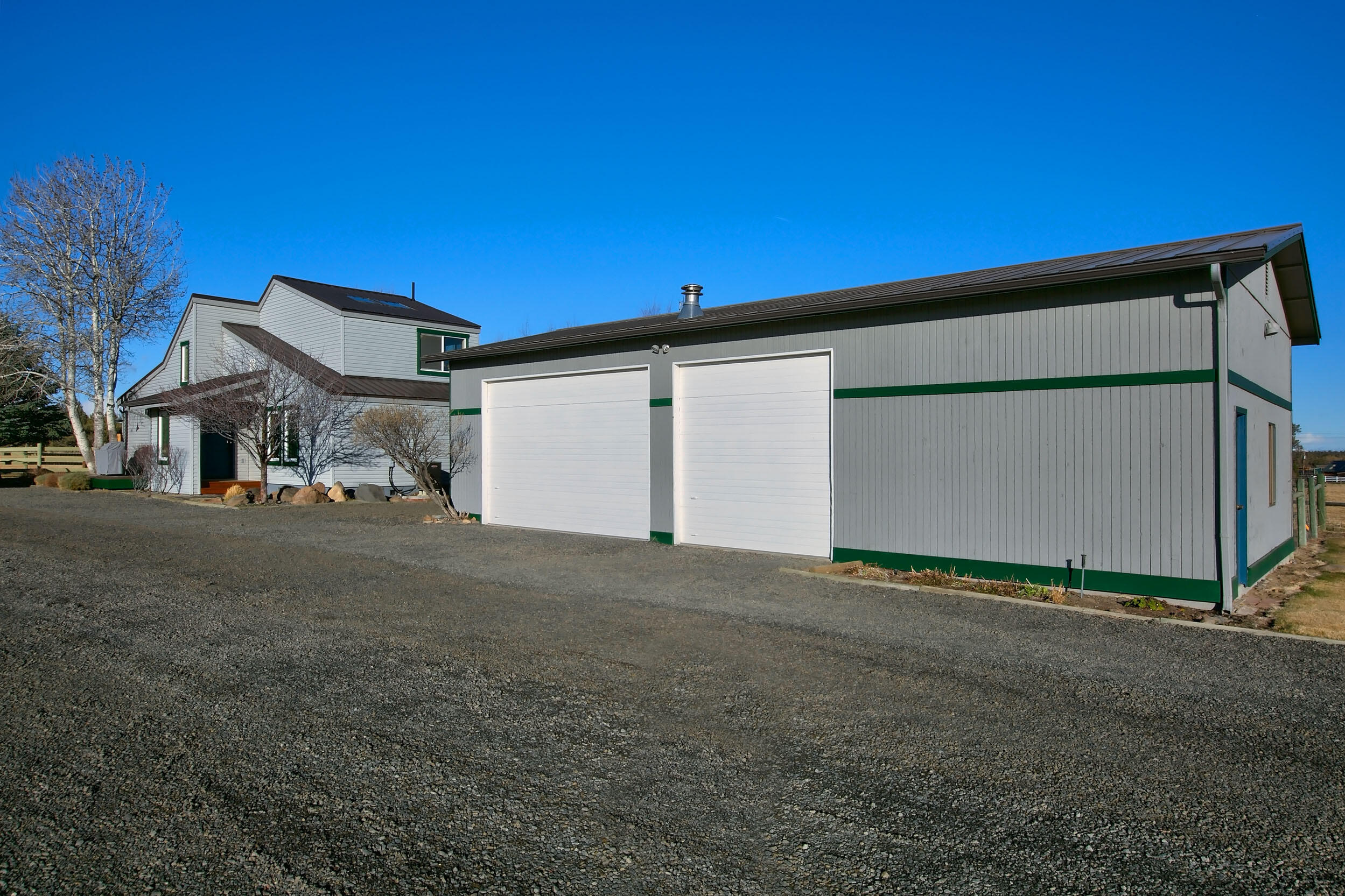 20155 Marsh Road Bend, OR 97703 - Photo 24 of 39 a front view of a house with a yard and garage