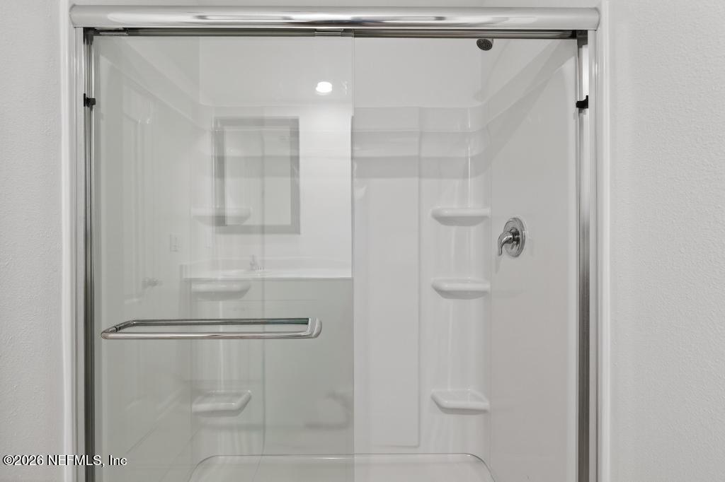 45 Seaport Breeze Road St. Augustine, FL 32095 - Photo 73 of 88 a bathroom with a glass shower door