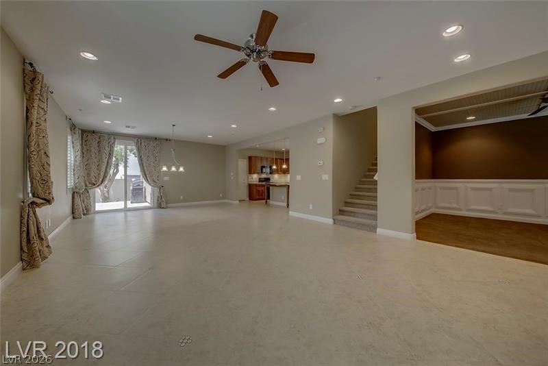 3144 Whitfeild Avenue Henderson, NV 89044 - Photo 55 of 55 An open floorplan living area features tile flooring, recessed lighting, and an elegant dining space with wainscoting.