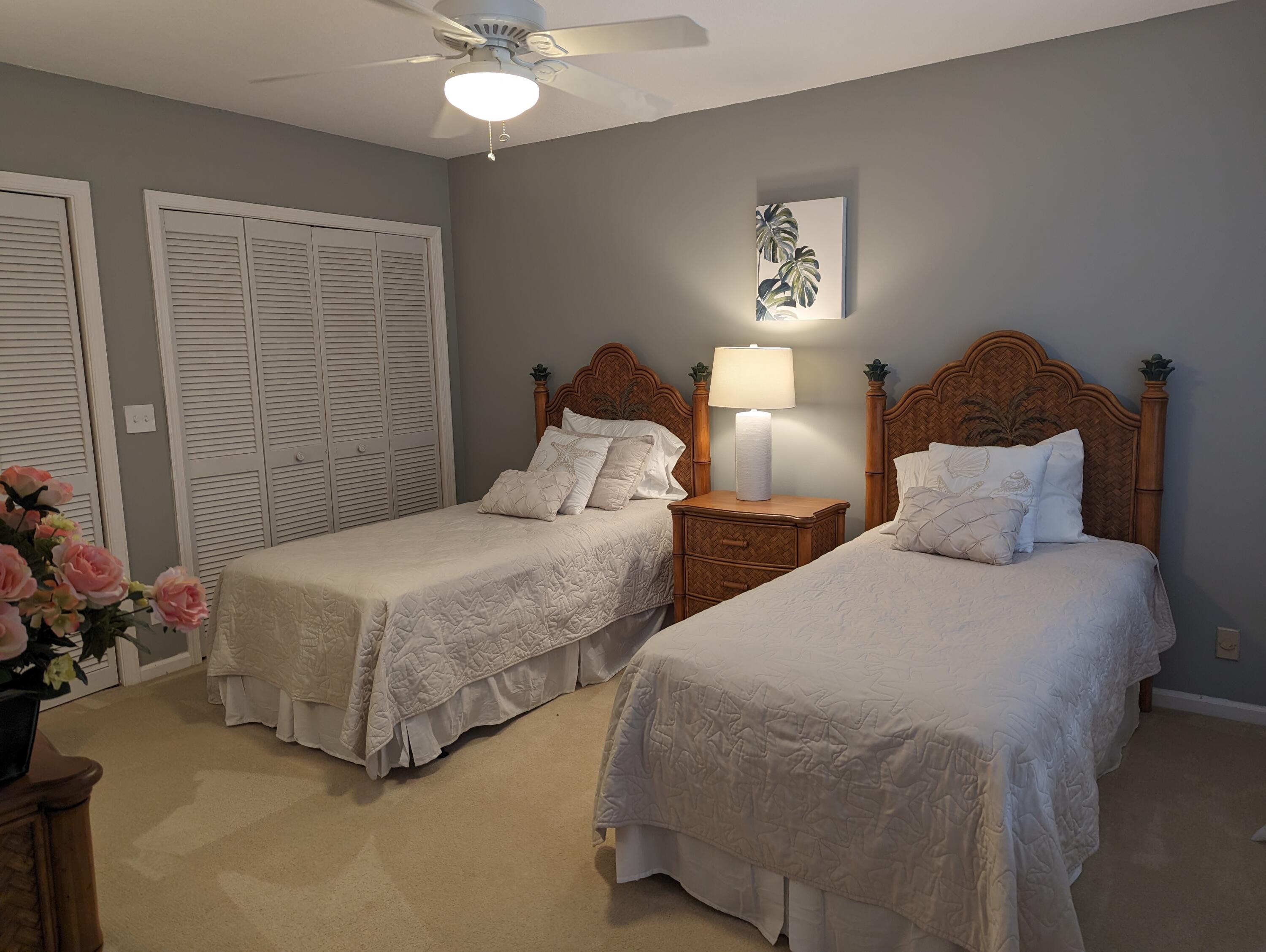 17081 Waterbend Drive, Unit 228 Jupiter, FL 33477 - Photo 15 of 21 a bedroom with two beds and a potted plant