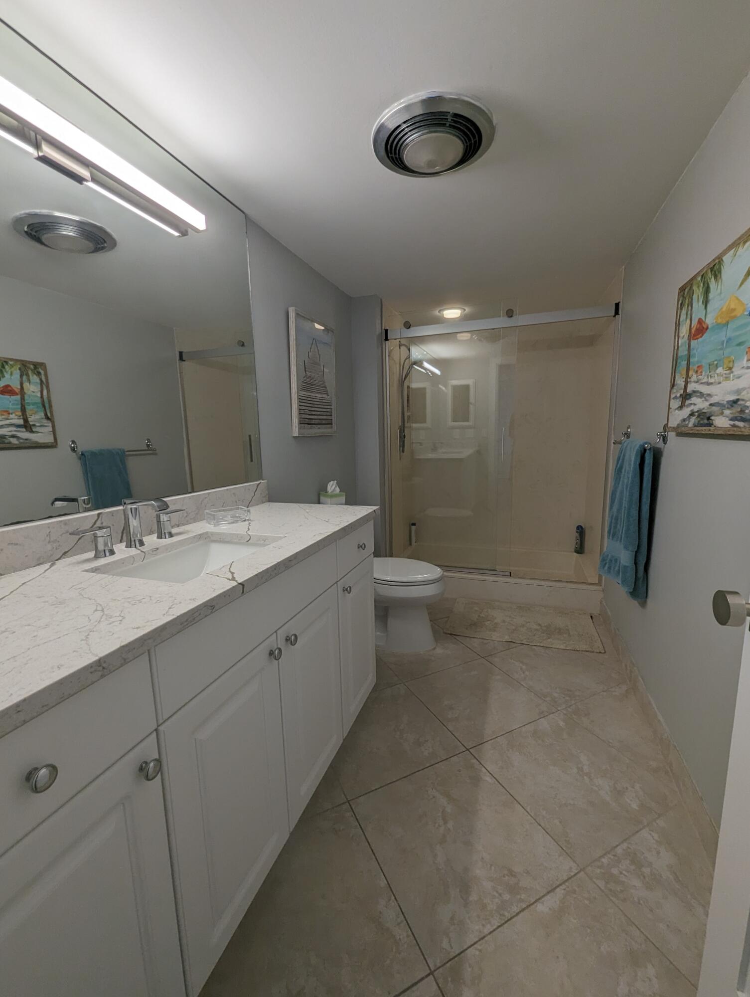 17081 Waterbend Drive, Unit 228 Jupiter, FL 33477 - Photo 17 of 21 a bathroom with a double vanity sink and mirror