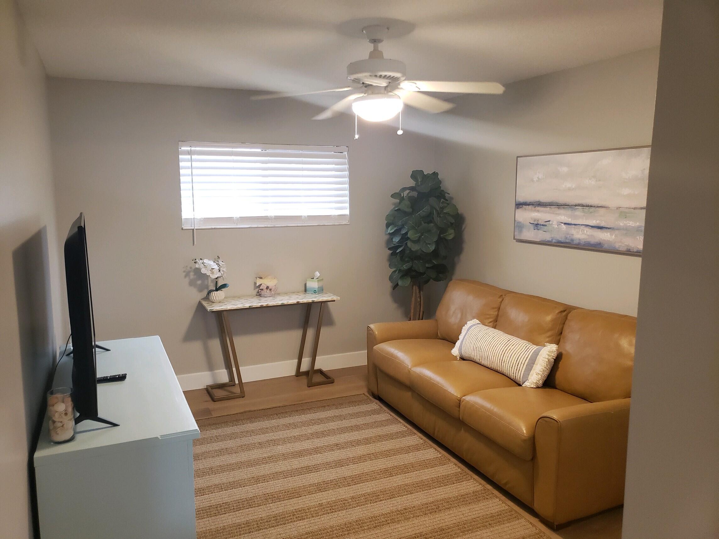 17081 Waterbend Drive, Unit 228 Jupiter, FL 33477 - Photo 18 of 21 a living room with furniture and a flat screen tv