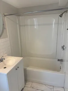 a bathroom with a bathtub and a sink