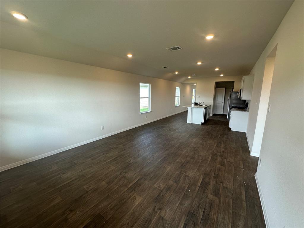 563 Evergreen Sumac Loop Kyle, TX 78640 - Photo 17 of 18 An open floorplan seamlessly connects the living area with a functional kitchen island.