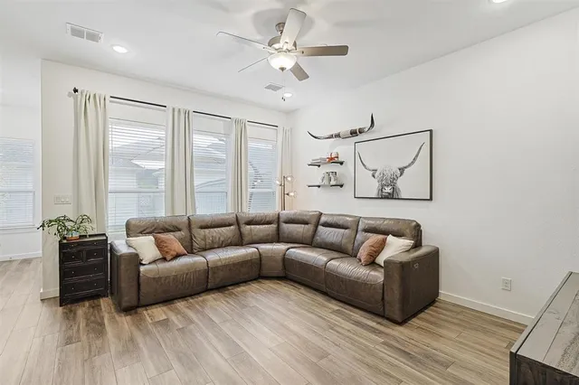 a living room with furniture and a large window