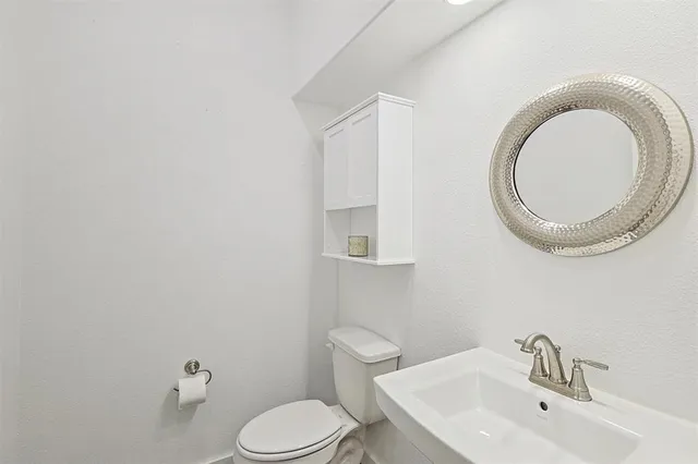 a bathroom with a toilet and a sink