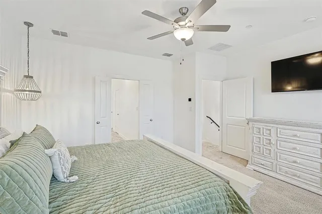 a bedroom with a large bed and a flat screen tv