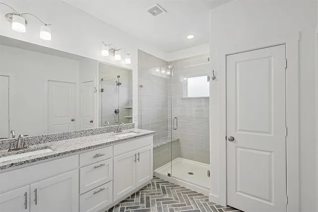 a bathroom with a shower sink double and mirror