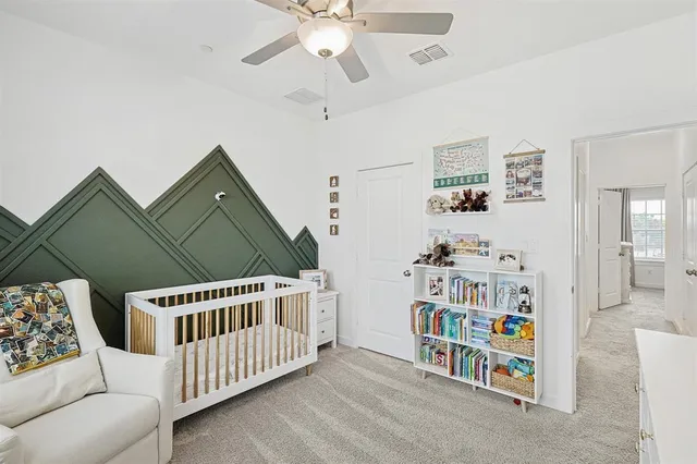 a bedroom with furniture and a book shelf