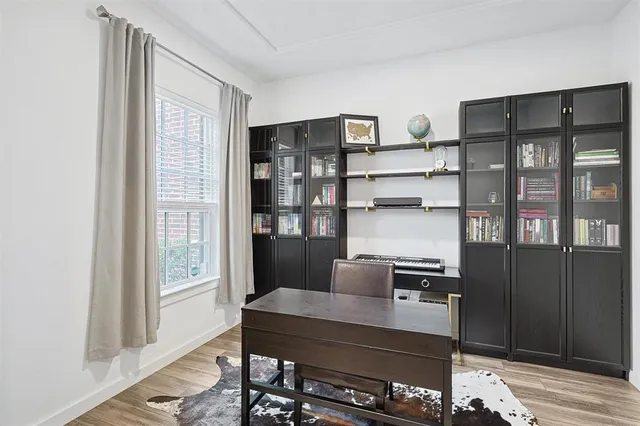 a view of a workspace with furniture and window