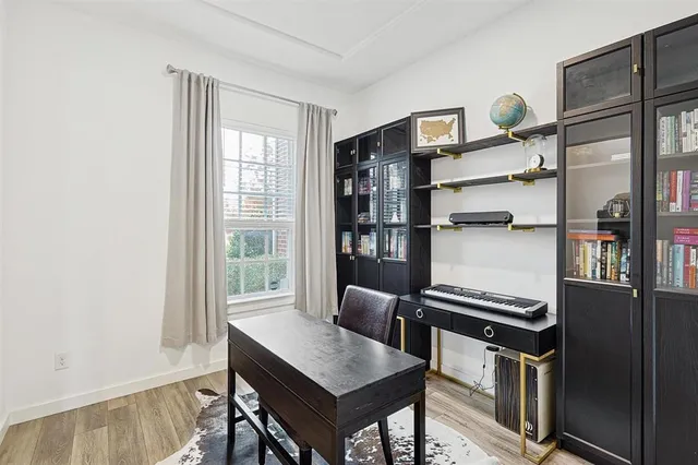 a view of a workspace with furniture and a window