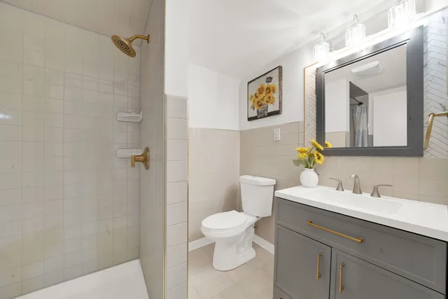 a bathroom with a sink a toilet and a mirror