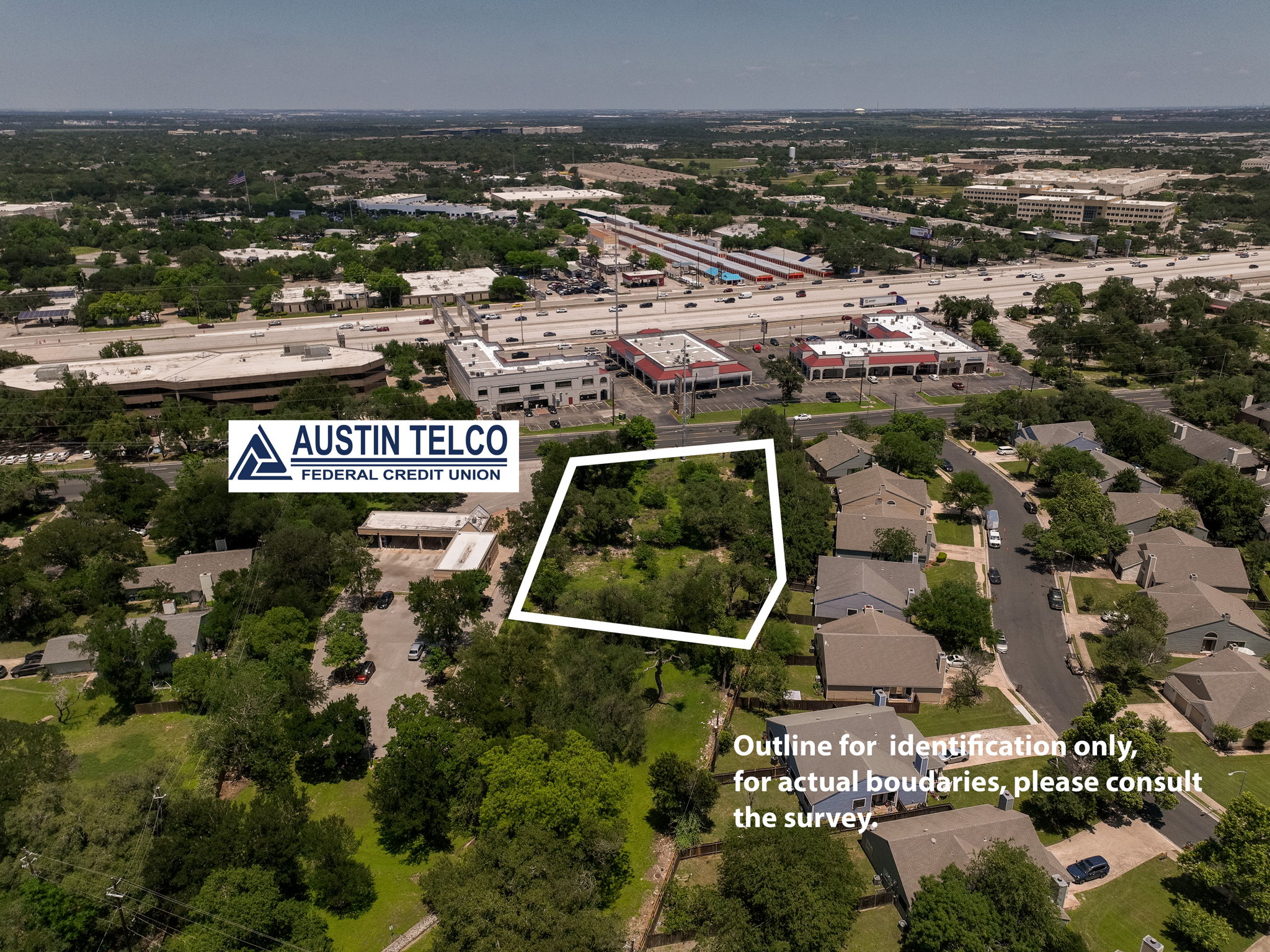 12182 Jollyville Road Austin, TX 78759 - Photo 19 of 25 Aerial view of a rectangular undeveloped parcel, bordered by residential structures and commercial buildings