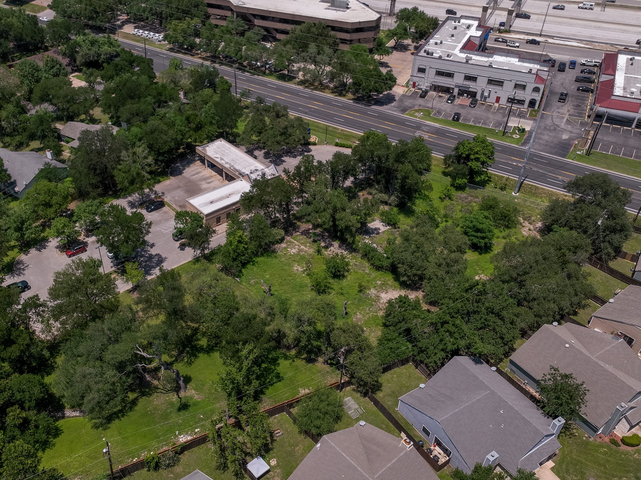 12182 Jollyville Road Austin, TX 78759 - Photo 25 of 25 Expansive green space featuring mature trees and a flat topography
