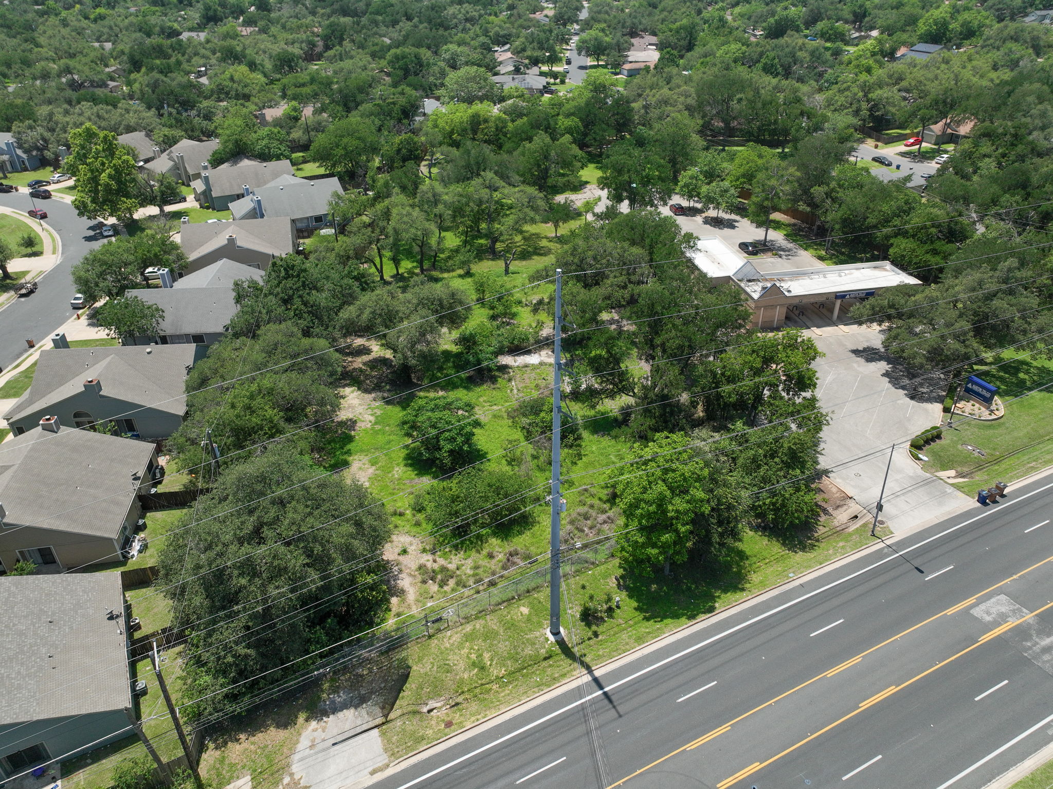 12182 Jollyville Road Austin, TX 78759 - Photo 3 of 25 Expansive open lot featuring mature trees and green landscaping