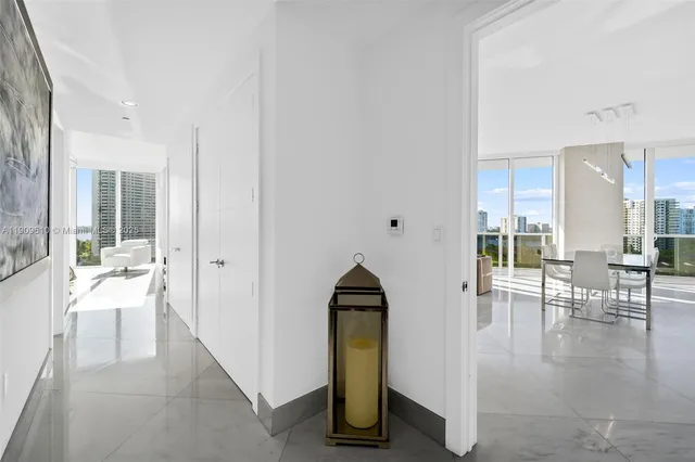 a spacious bedroom with a bed and a chandelier