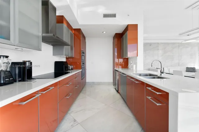 a large kitchen with kitchen island a large window