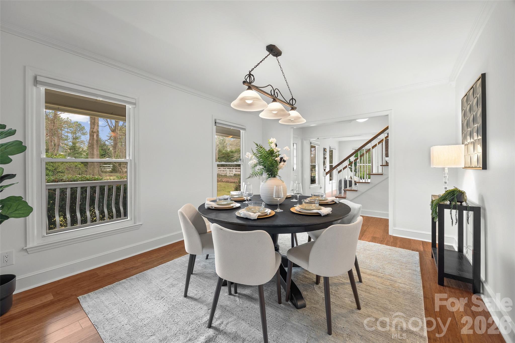 3320 Tilley Morris Road Matthews, NC 28105 - Photo 14 of 48 a dining room with furniture a chandelier and wooden floor