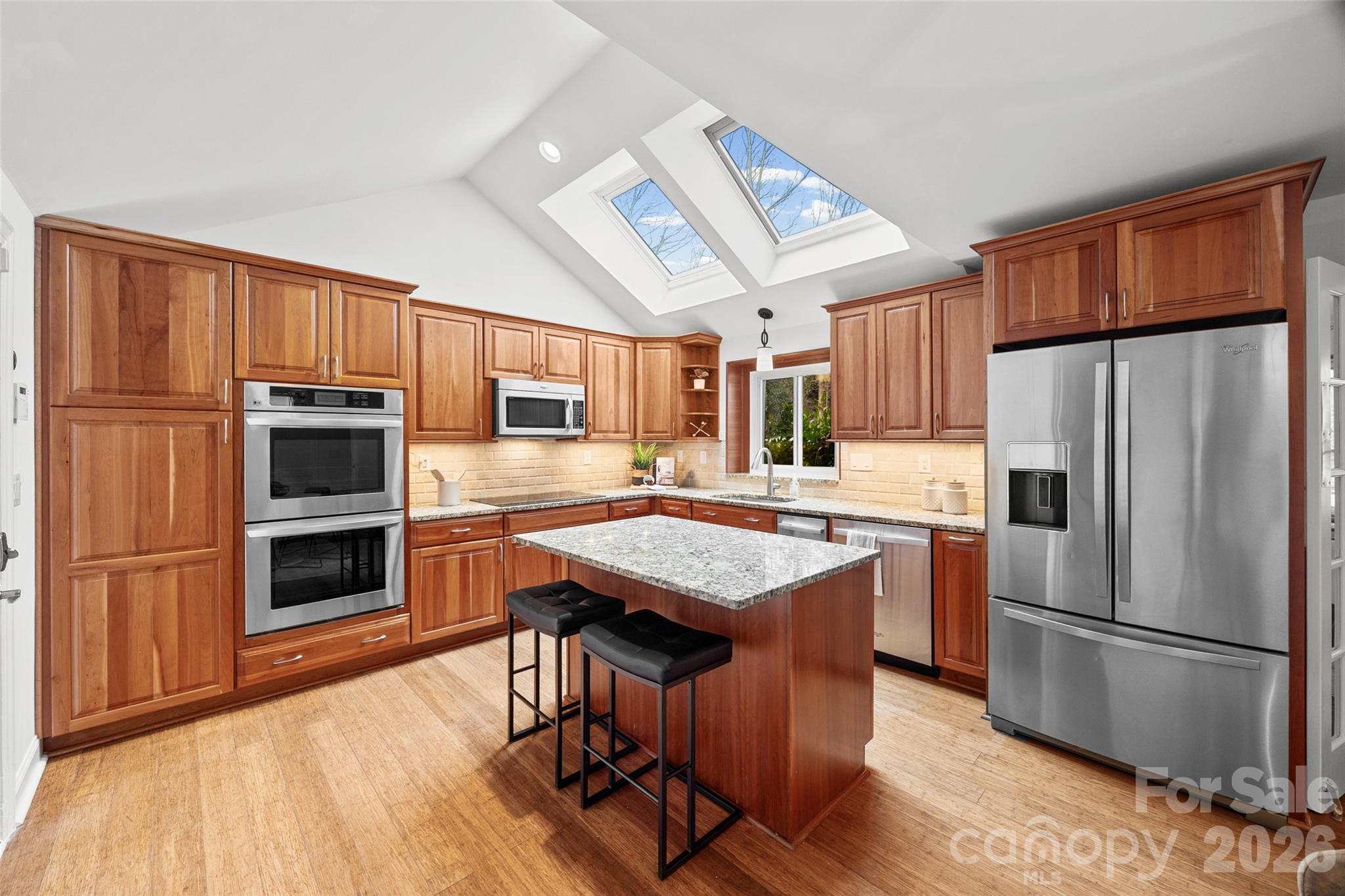 3320 Tilley Morris Road Matthews, NC 28105 - Photo 16 of 48 a kitchen with stainless steel appliances a stove a refrigerator a sink dishwasher and a oven with wooden floor