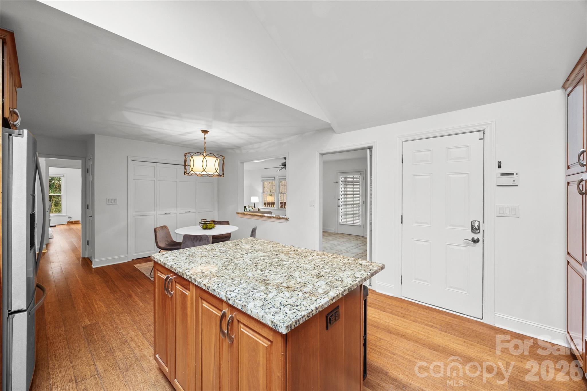 3320 Tilley Morris Road Matthews, NC 28105 - Photo 17 of 48 a living room with kitchen island furniture and a wooden floor