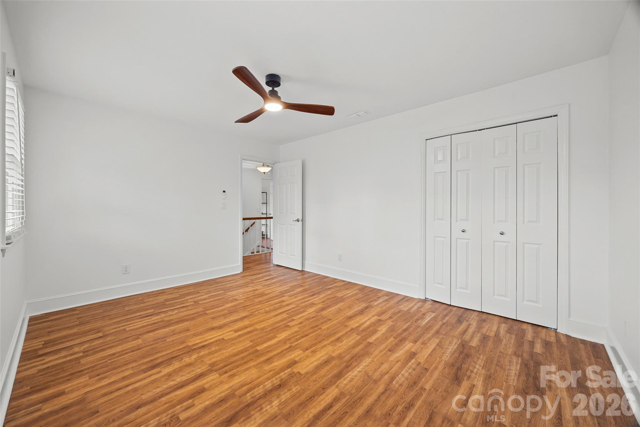 3320 Tilley Morris Road Matthews, NC 28105 - Photo 26 of 48 a view of empty room with wooden floor and fan