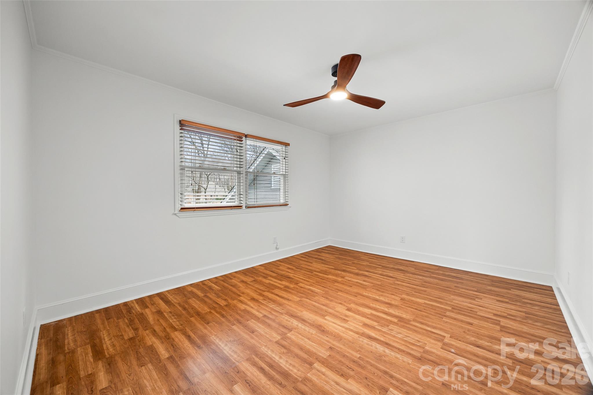 3320 Tilley Morris Road Matthews, NC 28105 - Photo 28 of 48 a view of an empty room with wooden floor and a window