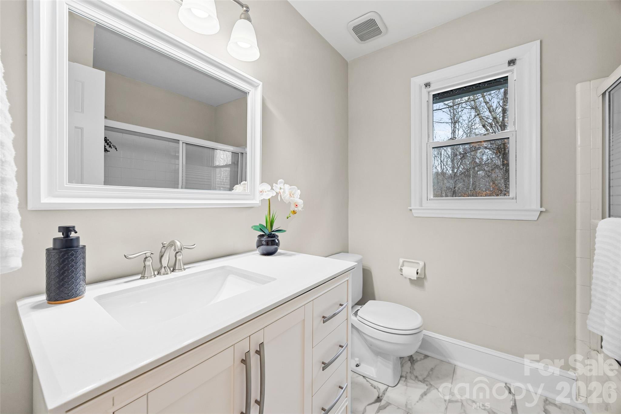 3320 Tilley Morris Road Matthews, NC 28105 - Photo 29 of 48 a bathroom with a toilet a sink and mirror