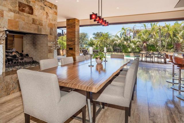 a living room with fireplace furniture and a large window