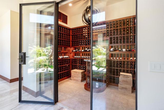 a bedroom with a bed and large windows