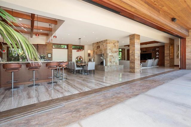 a view of a swimming pool with outdoor seating