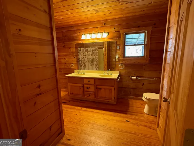 a view of a room with wooden floors and brick walls