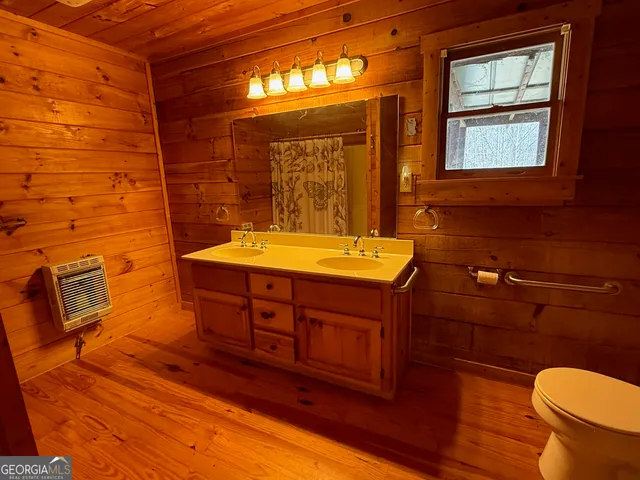 a view of an empty room with a fireplace and a window