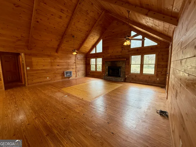 a view of a room with wooden floor