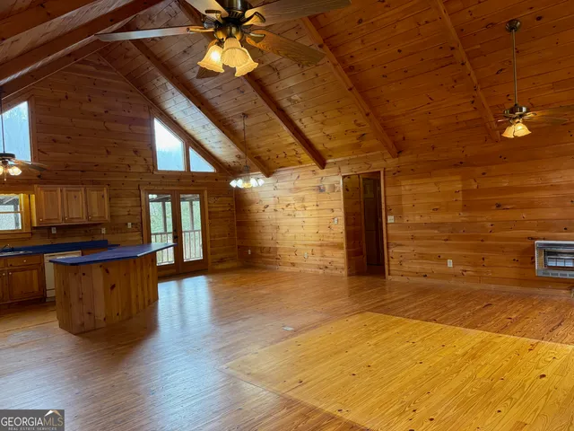 a view of a livingroom with a ceiling fan and window
