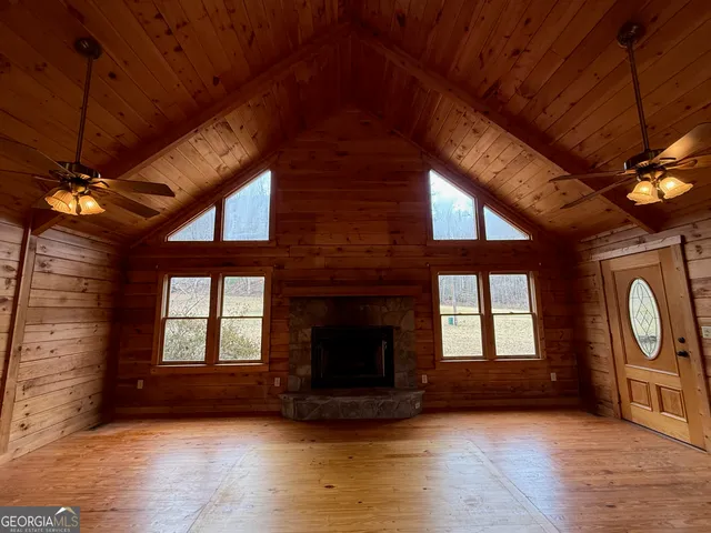 a big yard with large trees and a barn