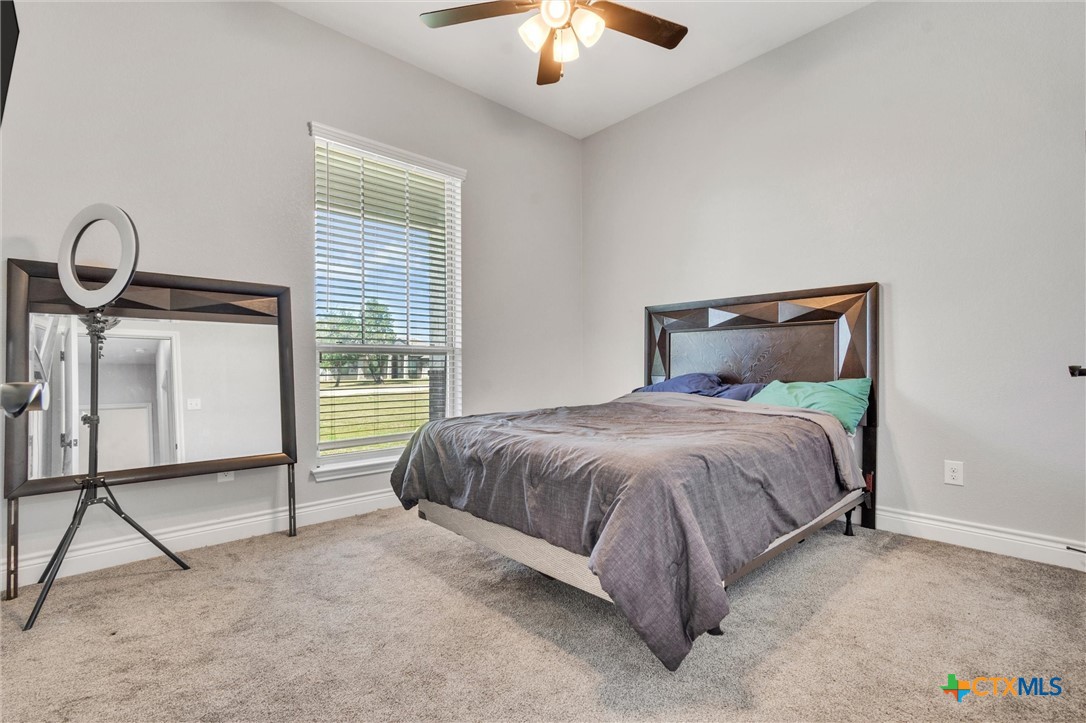 3919 Gracey Lane Kempner, TX 76539 - Photo 26 of 44 a bedroom with a bed and a chandelier
