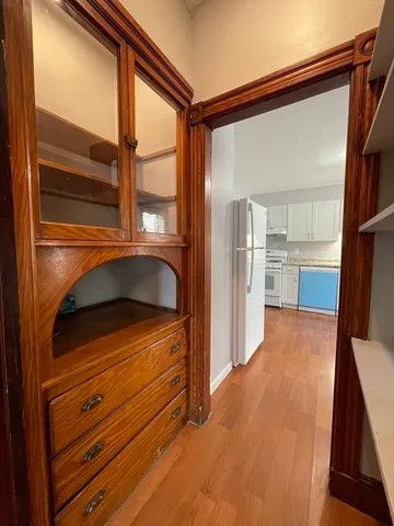 a view of a room with wooden floor and a window