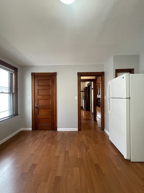 71 Mayfield Street, Unit 2 Boston, MA 02125 - Photo 20 of 33 a view of empty room with wooden floor and refrigerator