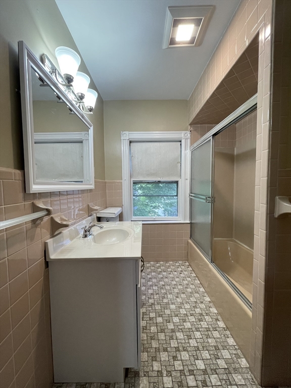 71 Mayfield Street, Unit 2 Boston, MA 02125 - Photo 24 of 33 a bathroom with a sink a large mirror and a bathtub