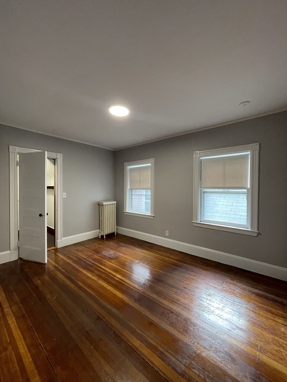 71 Mayfield Street, Unit 2 Boston, MA 02125 - Photo 27 of 33 a view of an empty room with wooden floor and a window