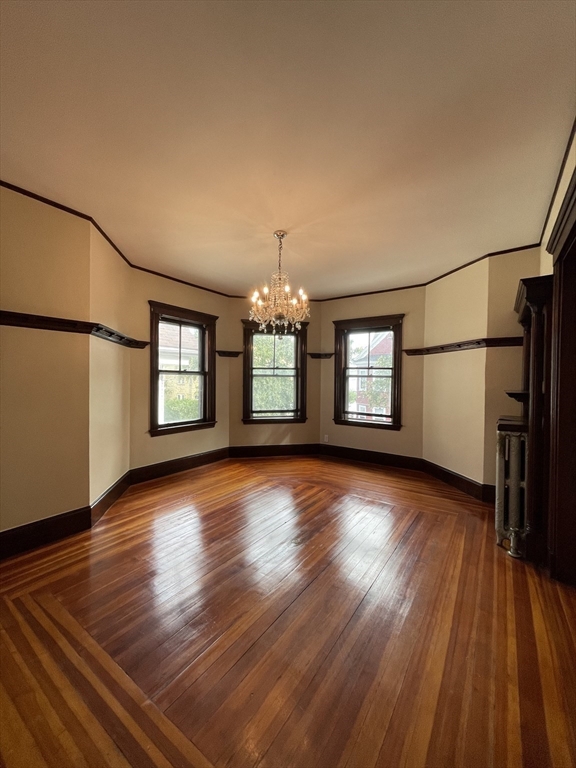 71 Mayfield Street, Unit 2 Boston, MA 02125 - Photo 6 of 33 an empty room with wooden floor and windows