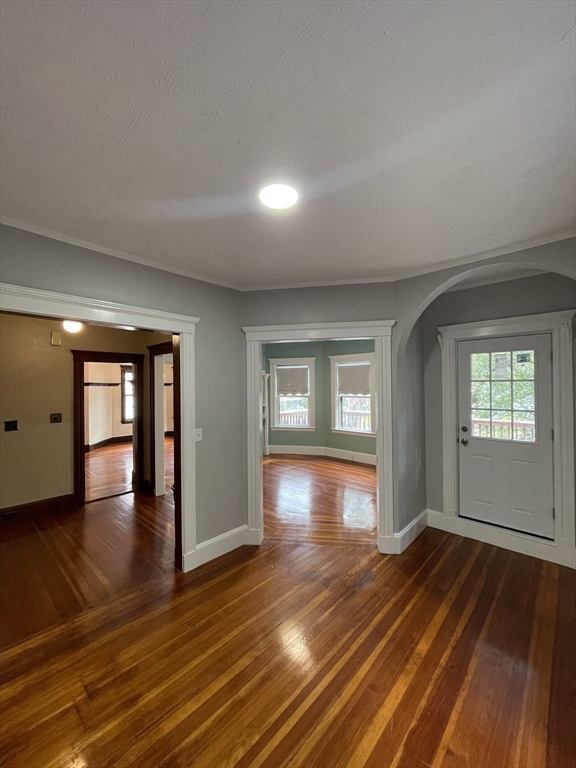 71 Mayfield Street, Unit 2 Boston, MA 02125 - Photo 9 of 33 an empty room with wooden floor and windows